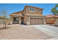 Charming two-story home featuring a neutral color palette, tile roof, and a two-car garage at 4318 W Apollo Rd, Laveen, AZ 85339