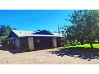 Spacious property with a covered parking area, lush landscaping, and a well-maintained lawn at 5016 W Sunrise Dr, Laveen, AZ 85339
