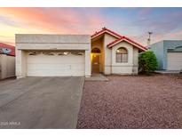 Charming single-story home with a red-tiled roof, well-kept landscaping, and an attached garage at 11358 E Jenan Dr, Scottsdale, AZ 85259