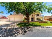 Stunning two-story home with a Spanish tile roof, a three-car garage, and mature landscaping at 119 E Palomino Dr, Tempe, AZ 85284