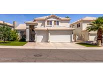 Charming two-story home with a three car garage and manicured lawn in a suburban neighborhood at 1343 E Amberwood Dr, Phoenix, AZ 85048