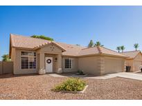 Charming single-story home with a tile roof, desert landscaping, and a welcoming front entrance with decorative wreath at 1381 W Gary Dr, Chandler, AZ 85224