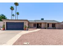 Charming single-story home featuring mature palm trees and a low-maintenance desert landscape at 1809 S Heritage --, Mesa, AZ 85210