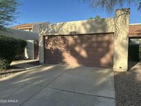 Home's attached garage with a brown door offers convenient parking and storage at 1913 S River Dr, Tempe, AZ 85281