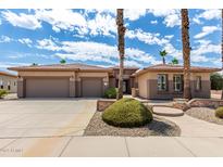 Charming single-story home featuring a three-car garage and meticulous desert landscaping at 20332 N Denizen Dr, Surprise, AZ 85387