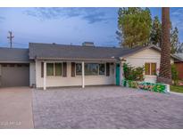 Charming single-story home featuring a well-manicured yard, a stylish brick driveway, and vibrant curb appeal at 4036 N 40Th Pl, Phoenix, AZ 85018