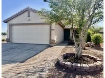 Charming single-story home featuring a two-car garage and a brick-lined walkway at 4104 N 113Th Ave, Phoenix, AZ 85037