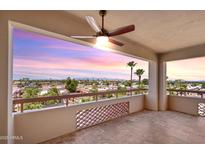 Enjoy city views from this balcony with tile flooring and decorative partition, illuminated by a ceiling fan at 4200 N Miller Rd # 504, Scottsdale, AZ 85251