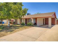 Charming single-story home with a concrete driveway and a well-maintained lawn and mature tree at 5343 W Coronado Rd, Phoenix, AZ 85035