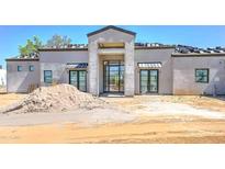 A modern home's front exterior features a stylish entry and an unfinished roof at 6426 E Turquoise Ave, Paradise Valley, AZ 85253