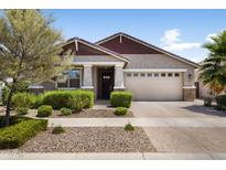 Charming single-story home featuring a two-car garage, desert landscaping, and a welcoming entryway at 10165 E Gamma Ave, Mesa, AZ 85212