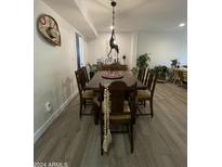 Inviting dining room featuring a unique light fixture and a sombrero on the wall at 12421 N 41St Pl, Phoenix, AZ 85032