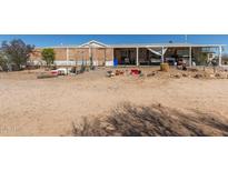 Exterior shot of the home with a porch and desert landscaping at 1347 S Oak Rd, Maricopa, AZ 85139