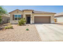 Charming single-story home with well-maintained landscaping, a two-car garage and inviting curb appeal at 1748 W Cameron Blvd, Coolidge, AZ 85128