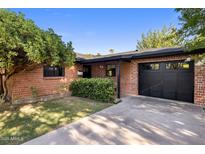 Charming single-story brick home featuring a manicured lawn and a one-car garage at 1825 E Palo Verde Dr, Phoenix, AZ 85016