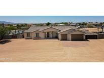 Sprawling desert home featuring a two-car garage, charming front porch and low-maintenance landscaping at 19711 W Colter St, Litchfield Park, AZ 85340