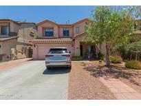 Charming two-story home features a well-manicured front yard and a spacious driveway at 19719 N Castille Dr, Maricopa, AZ 85138