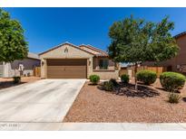 Charming single-story home featuring a two-car garage, desert landscaping, and a neutral color scheme at 20128 W Jackson St, Buckeye, AZ 85326