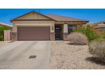 Charming single-story home with a two-car garage and low-maintenance desert landscaping at 205 N 107Th Dr, Avondale, AZ 85323