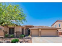 Beautiful single-story home featuring a well-maintained front yard, desert landscaping and a 3-car garage at 26072 N 74Th Ave, Peoria, AZ 85383