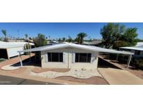 Charming manufactured home with a covered awning, landscaped front yard, and well maintained grounds at 3104 E Broadway Rd # 268, Mesa, AZ 85204
