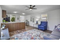 Bright living room with wood floors, neutral walls, stylish furnishings, and modern ceiling fan at 320 E Mckellips Rd # 25, Mesa, AZ 85201