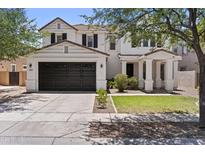 Beautiful two-story home featuring a dark brown garage door and a charming front porch at 3575 E Gary Way, Gilbert, AZ 85234