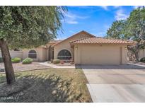 Charming one-story home featuring a tile roof, two-car garage, and mature landscaping, perfect for suburban living at 3882 S Hawthorn Dr, Chandler, AZ 85248