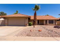 Charming single-story home featuring a well-manicured yard, a two-car garage, and a classic Southwestern design at 5354 E Ellis St, Mesa, AZ 85205