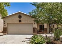 Charming single-story home with a two-car garage and desert landscaping in front yard at 1086 E Canyon Trail --, San Tan Valley, AZ 85143