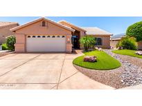 Charming single-story home with a well-manicured yard and a two-car garage at 15073 W Piccadilly Rd, Goodyear, AZ 85395