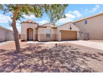 Charming single-story home featuring a low-maintenance desert landscape and a two-car garage at 1623 E Maplewood Ave, Buckeye, AZ 85326