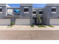 Contemporary townhome with private garage and balcony with modern gray stucco and a well-manicured landscape at 1851 W Vermont Ave, Phoenix, AZ 85015