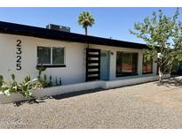 Charming single-story home featuring updated landscaping and a light blue front door at 2325 E Osborn Rd, Phoenix, AZ 85016