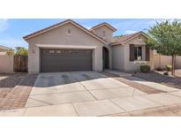 Charming single-story home featuring a two-car garage and landscaped front yard, showcasing modern design at 3326 N 31St St, Mesa, AZ 85213