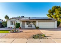 Charming home featuring well-maintained landscaping, solar panels, and a brick driveway at 4046 E Crocus Dr, Phoenix, AZ 85032