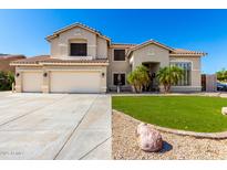 Charming two-story home featuring a three-car garage and well-manicured front yard with palm trees at 4530 E Decatur St, Mesa, AZ 85205