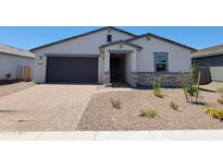 Charming single-story home featuring a stone-accented entrance and a low-maintenance desert landscape at 4811 W Hunter Trl, San Tan Valley, AZ 85144
