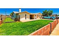 A single-Gathering home with a green lawn, brick perimeter and a blue truck in the driveway at 505 S Ridge --, Mesa, AZ 85204