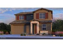 Charming two-story home with attached two car garage, stone accents, desert landscaping, and tile roof at 5062 N 88Th Dr, Glendale, AZ 85305