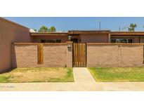 Charming front entrance with secure gated courtyard and nicely maintained landscape at 6008 W Augusta Ave, Glendale, AZ 85301