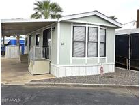 Charming single-story home featuring a covered entrance, white trim, and well-maintained landscaping at 730 S Country Club Dr # 62, Mesa, AZ 85210