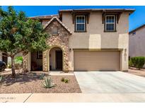 Charming two-story home featuring a stone-accented entrance and a well-maintained front yard at 820 E Constance Way, Phoenix, AZ 85042