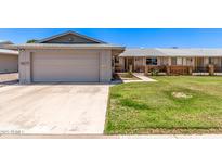 Charming single-story home showcasing a well-maintained lawn and inviting curb appeal at 10651 W Saratoga Cir, Sun City, AZ 85351