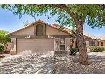 Charming single-story home with a neutral color palette, attached two-car garage, and desert landscaping at 1330 W Butler Dr, Chandler, AZ 85224