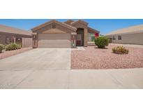 Charming single-story home featuring a two-car garage and low-maintenance desert landscaping at 16264 W Pioneer St, Goodyear, AZ 85338