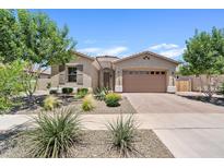 Charming single-story home featuring manicured desert landscaping and a two-car garage at 23038 E Twilight Dr, Queen Creek, AZ 85142