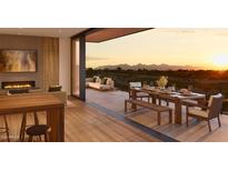 Beautiful balcony view with mountain backdrop, dining area, and lounge area with a fireplace at 4849 N Camelback Ridge Rd # B308, Scottsdale, AZ 85251