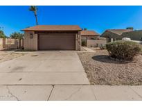 Charming single-story home featuring a brick facade, a two-car garage, and low-maintenance landscaping at 5101 W Purdue Ave, Glendale, AZ 85302