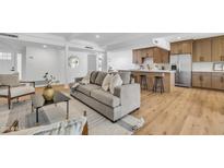 Open floor plan showcasing a modern living room seamlessly connected to a kitchen with stainless steel appliances at 6233 E Pinchot Ave, Scottsdale, AZ 85251